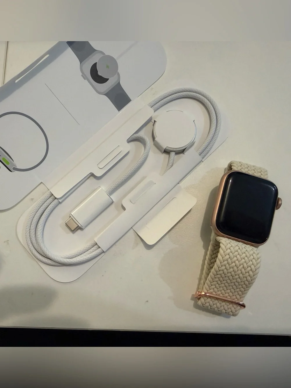Apple Watch SE with band and charger